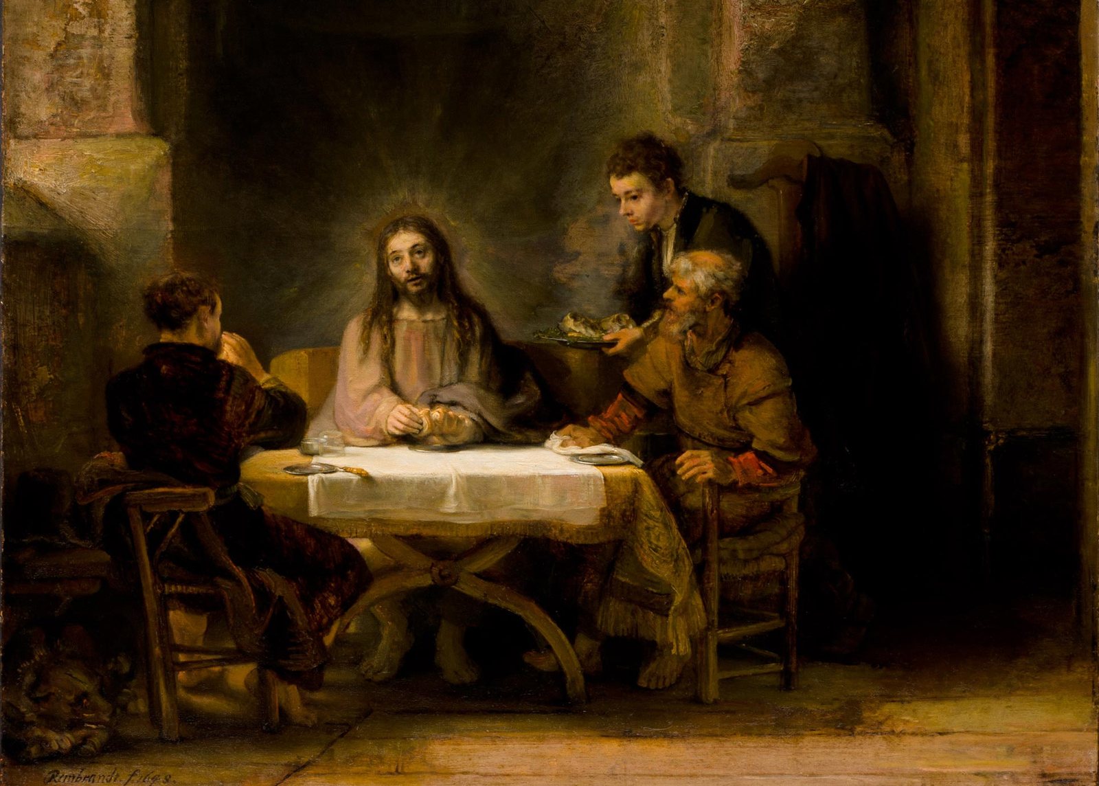 The Supper at Emmaus by Rembrandt, 1648, Louvre: the risen Christ, with a soft halo, breaks bread at a table as two disciples recognize him and a servant looks on